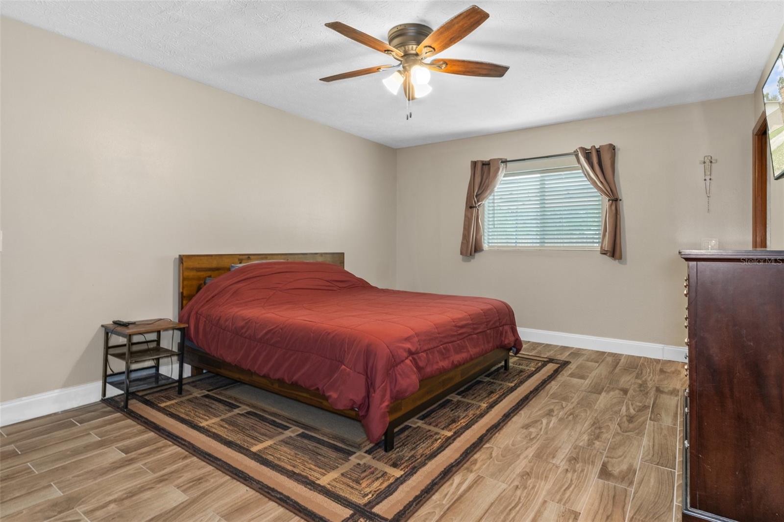 Master Bedroom with Wood Look Tile Flooring