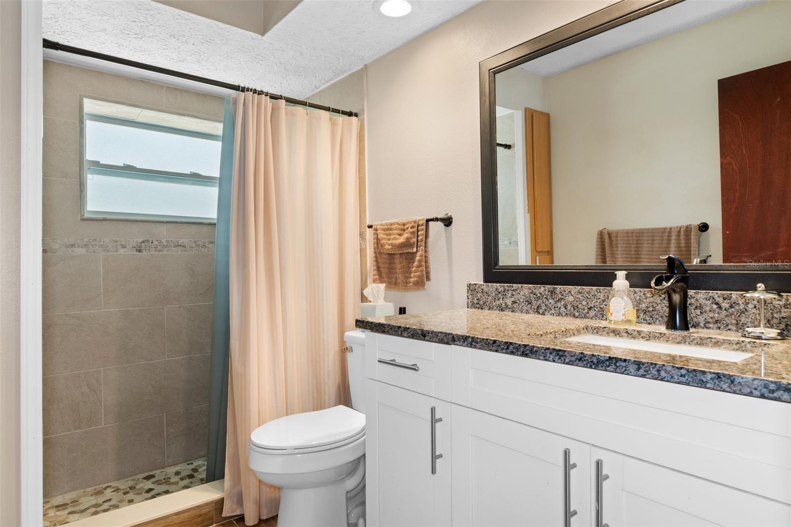 Updated Guest Bath with Granite and Tile Shower