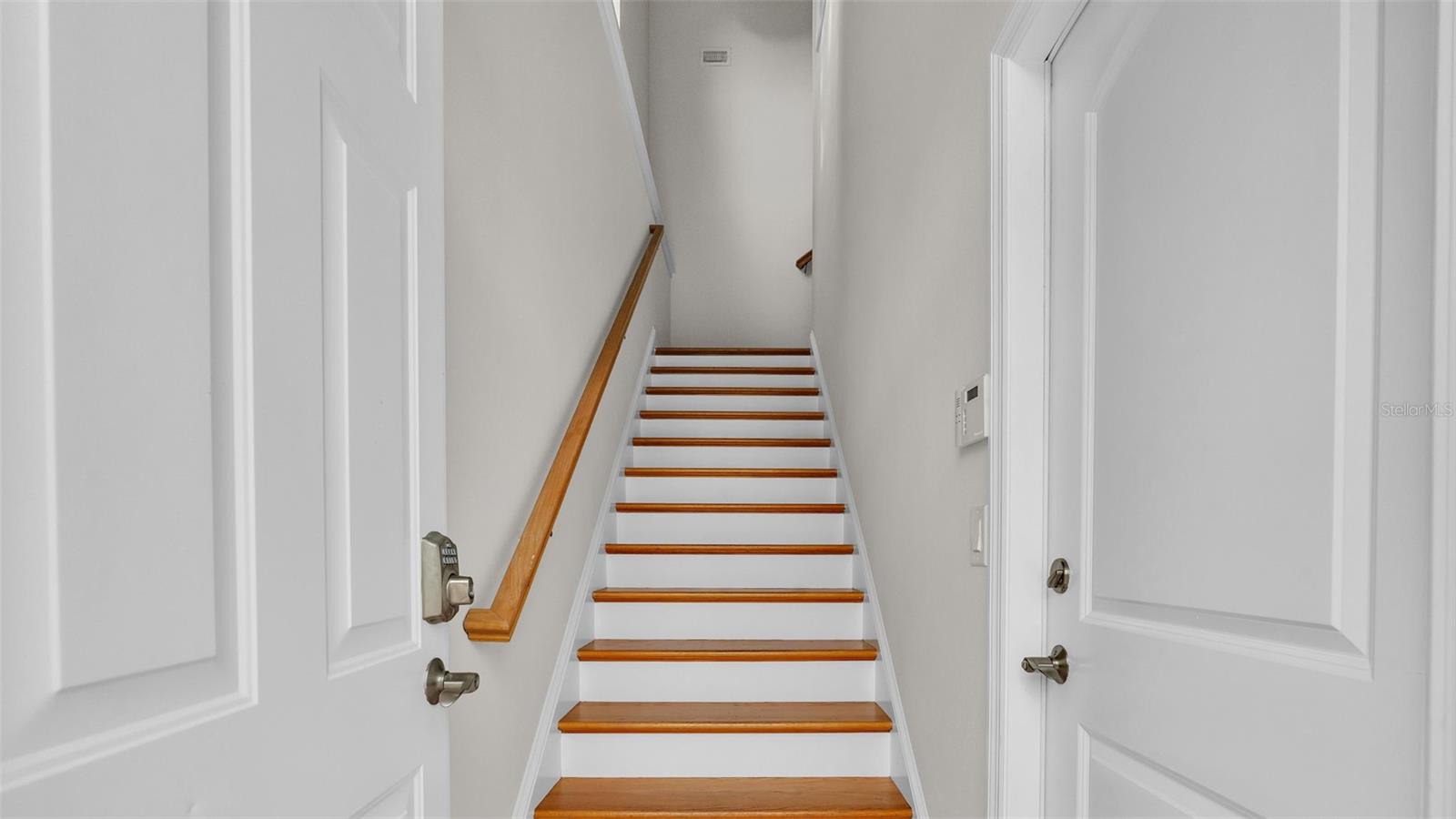 stairs lead to apartment above three car garage