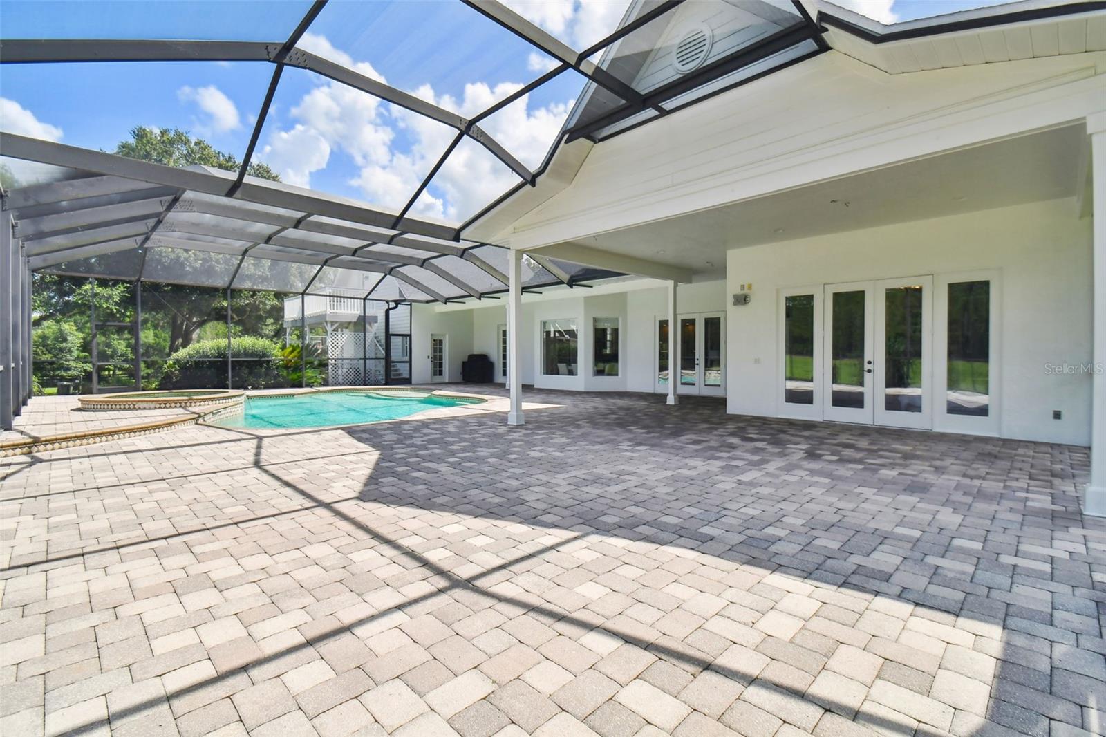 far left door is pool bath, screen door leads to wood stairs up to bonus room/game room/office