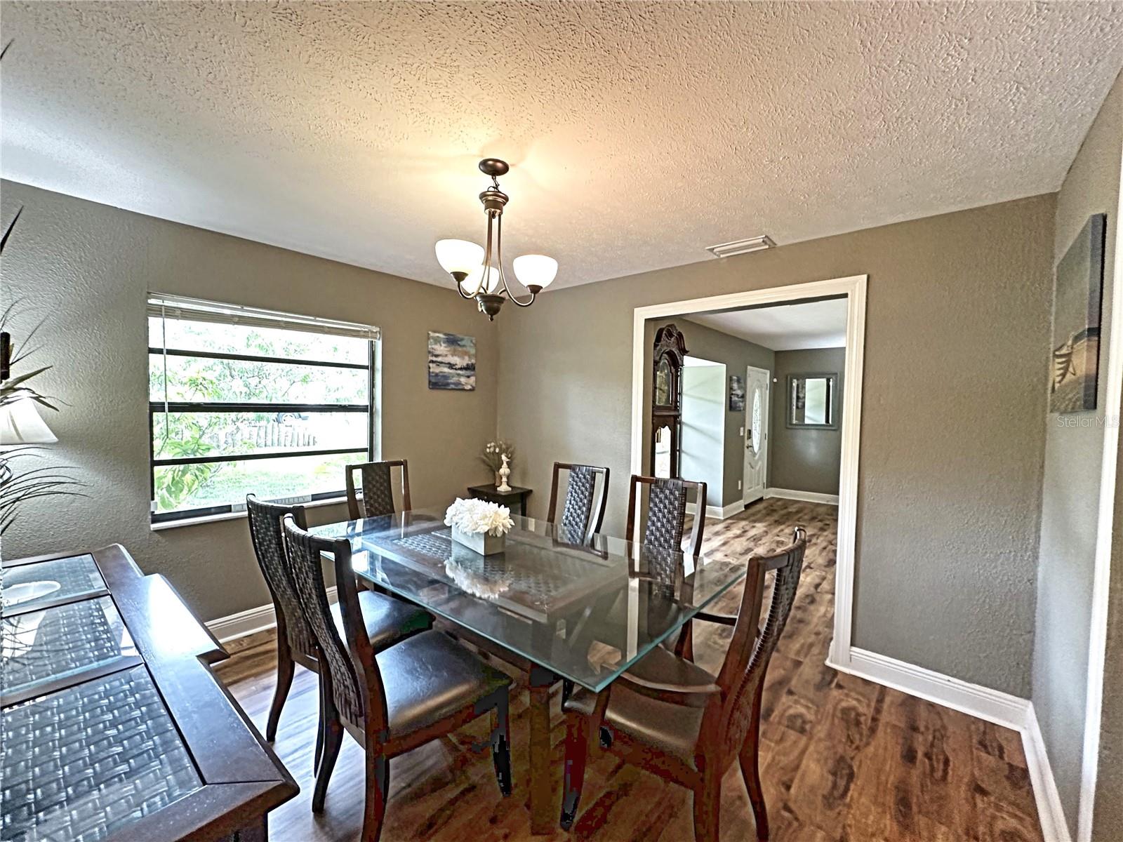 The dining room leads to the second living room and adjoins the kitchen.