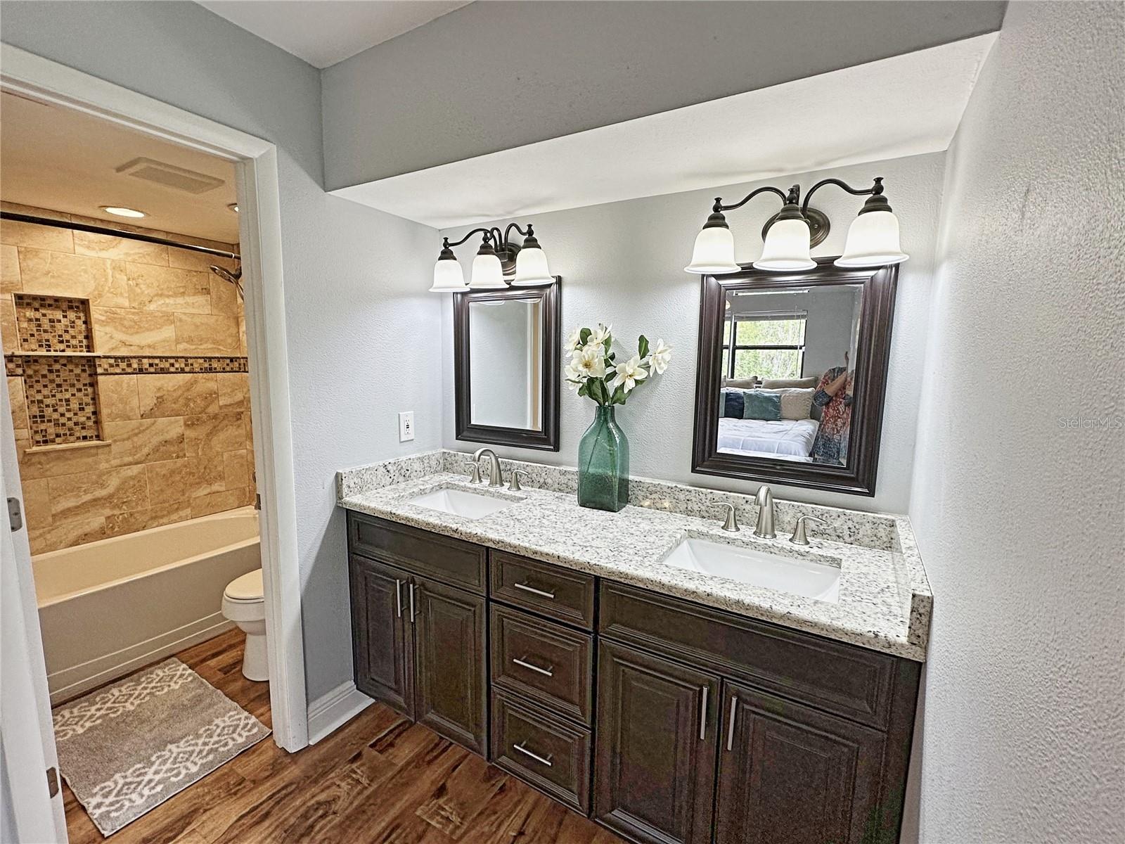 Primary bathroom.  The lovely vanity is open to the bedroom.