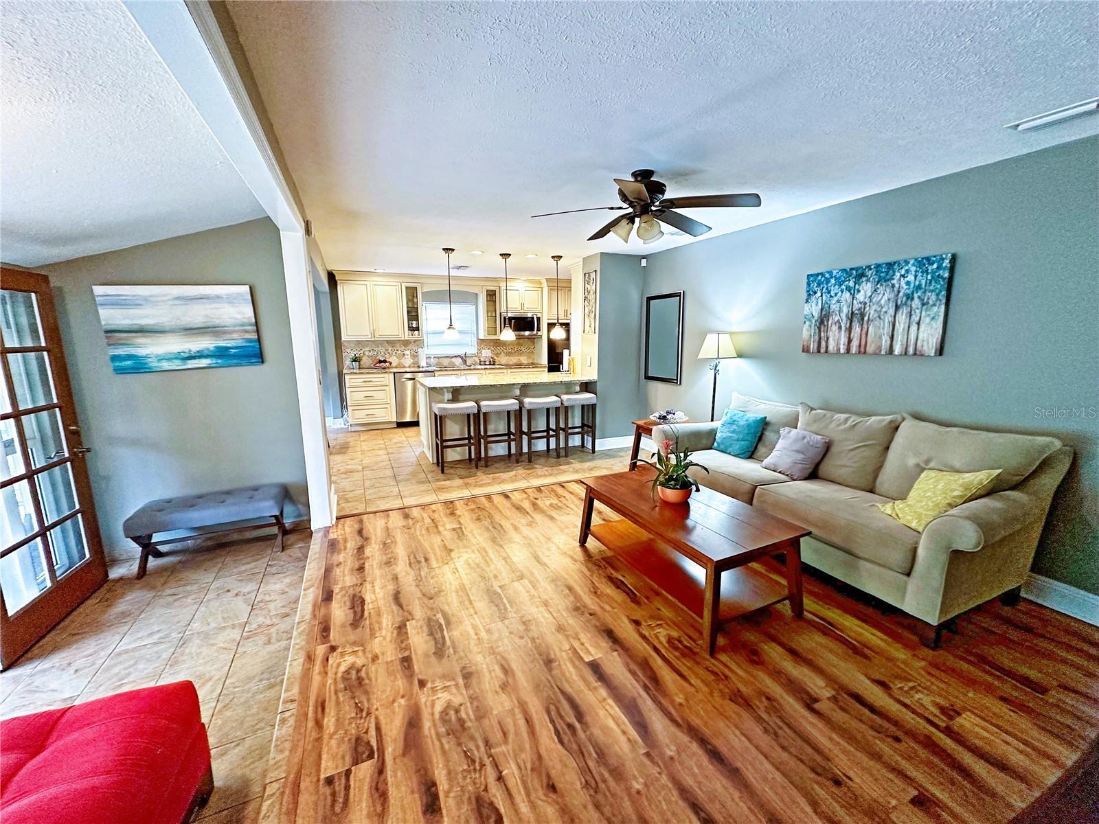 The living room opens onto the screened porch as well as the kitchen.