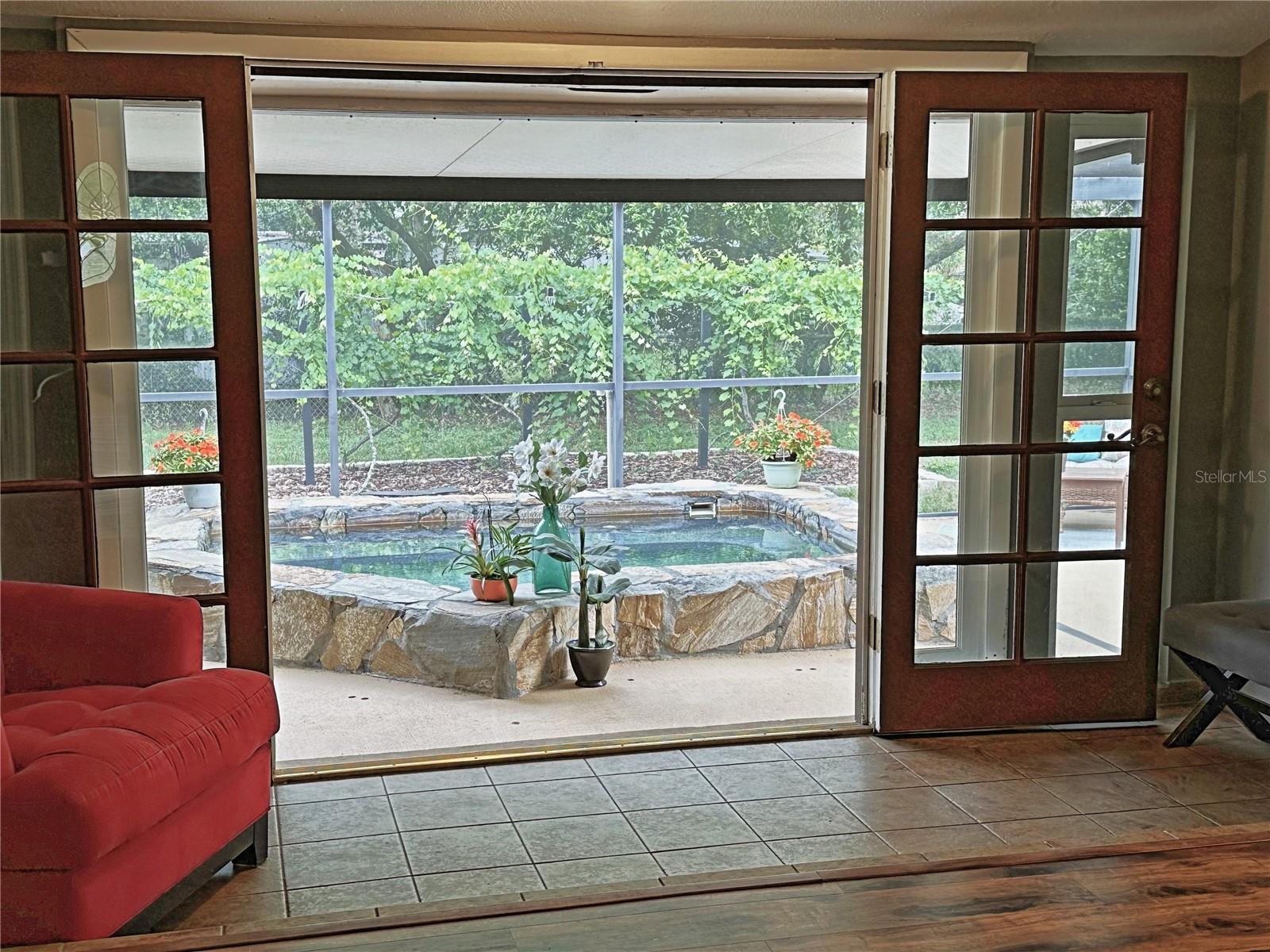 French doors open from the living room to the pool.