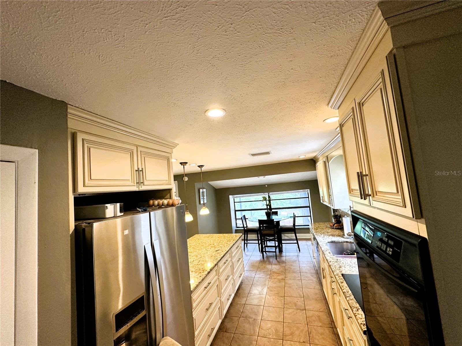 The kitchen is galley style but also opens onto the living and dining rooms with a lovely view of the back yard.  The kitchen has upgraded to mostly drawers for bottom cabinets.