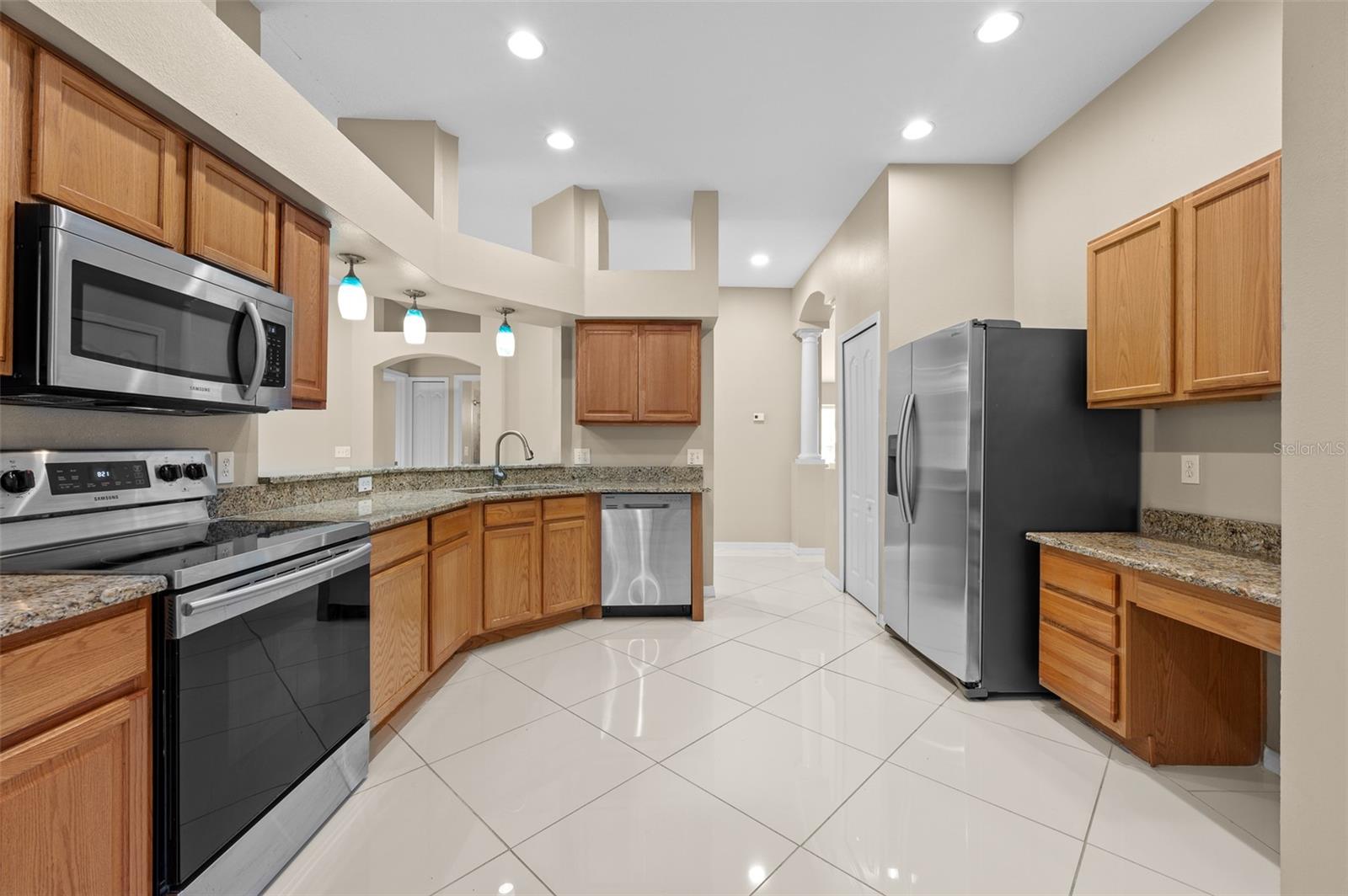 Open kitchen with granite counters and stainless steel appliances