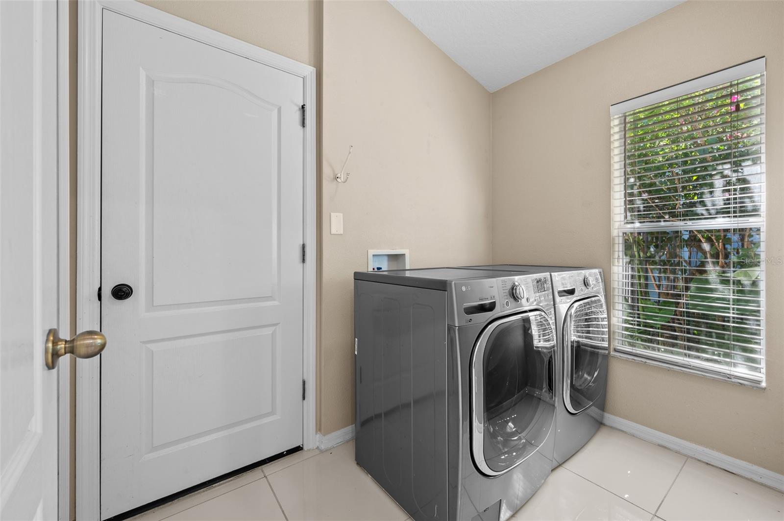 Front load washer and dryer in light and bright laundry room