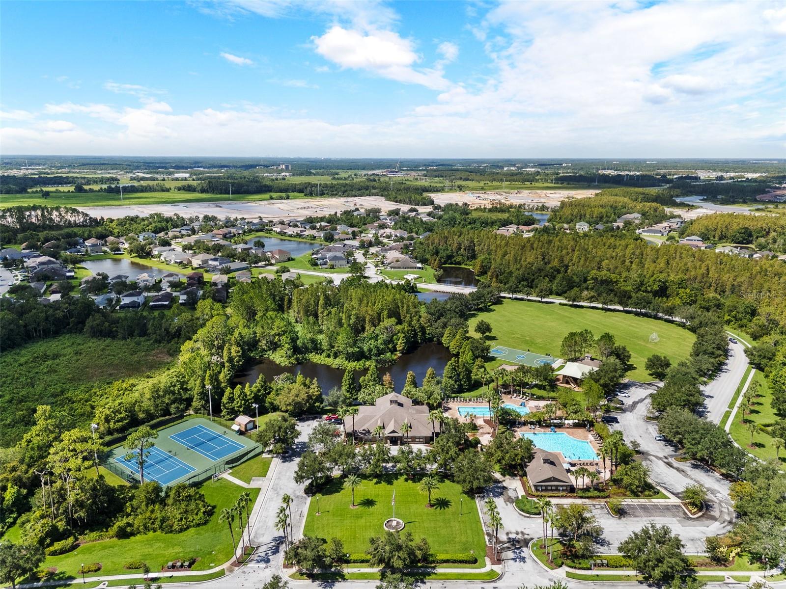 Overhead view of the Clubhouse and community sports center with tennis courts and pools