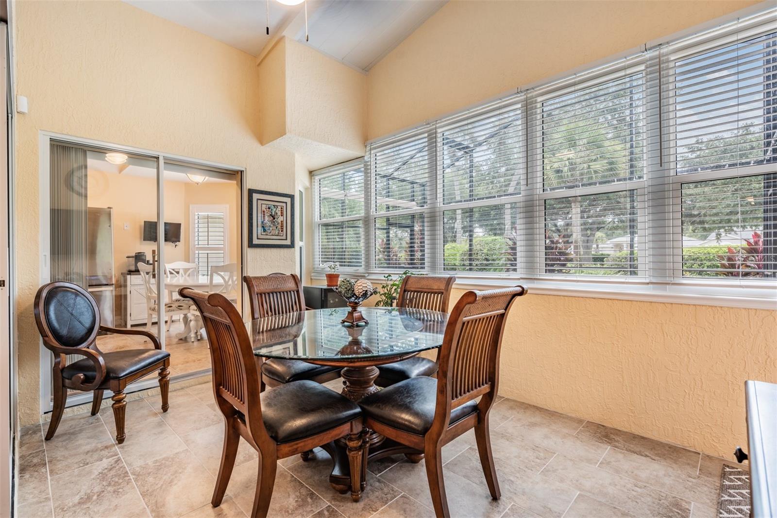 Enclosed Florida room serves as a great dining room with a view!