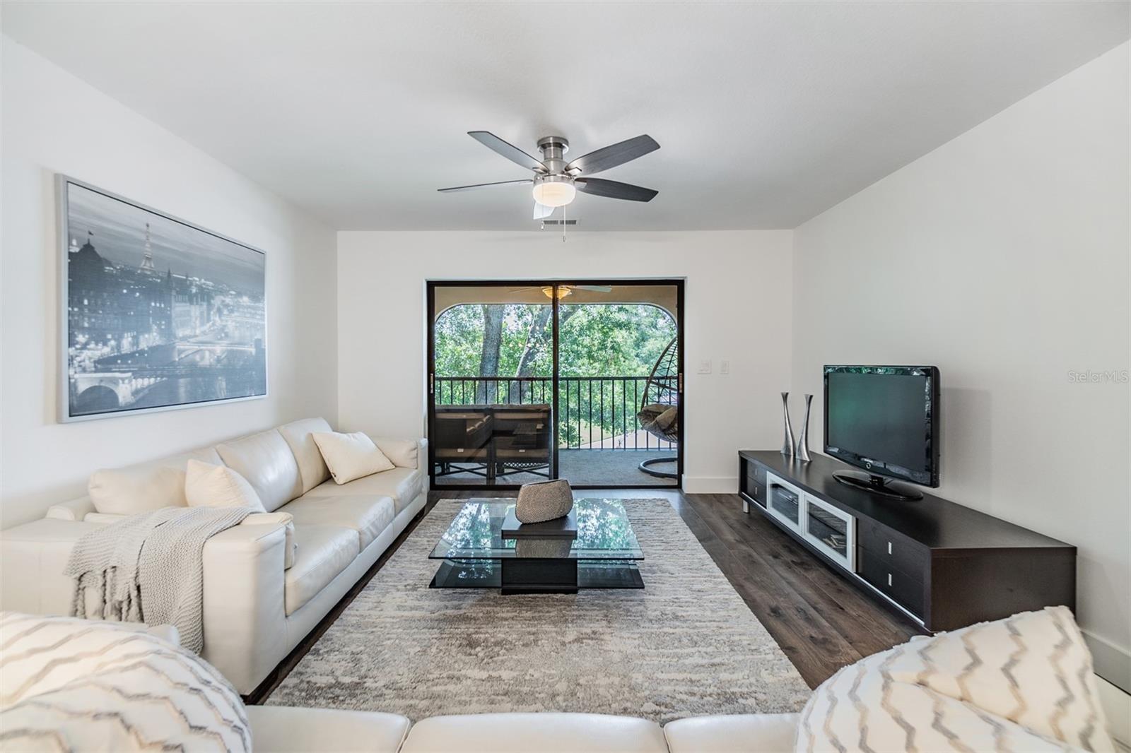 Living area with sliding door leading to the screened porch.