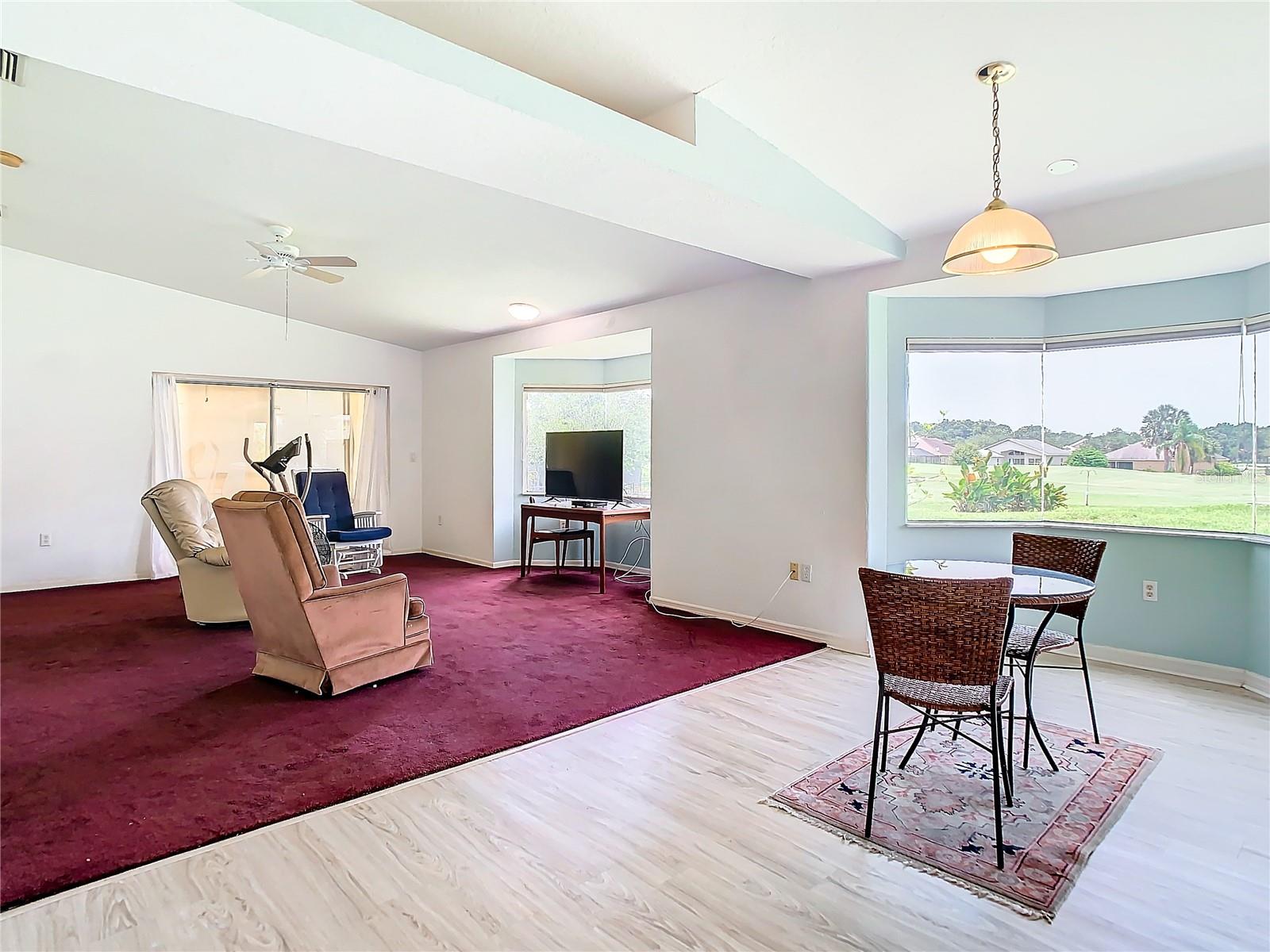 Great outside view from the dining area. The living room also has a bay window and a sliding door to access the lanai.