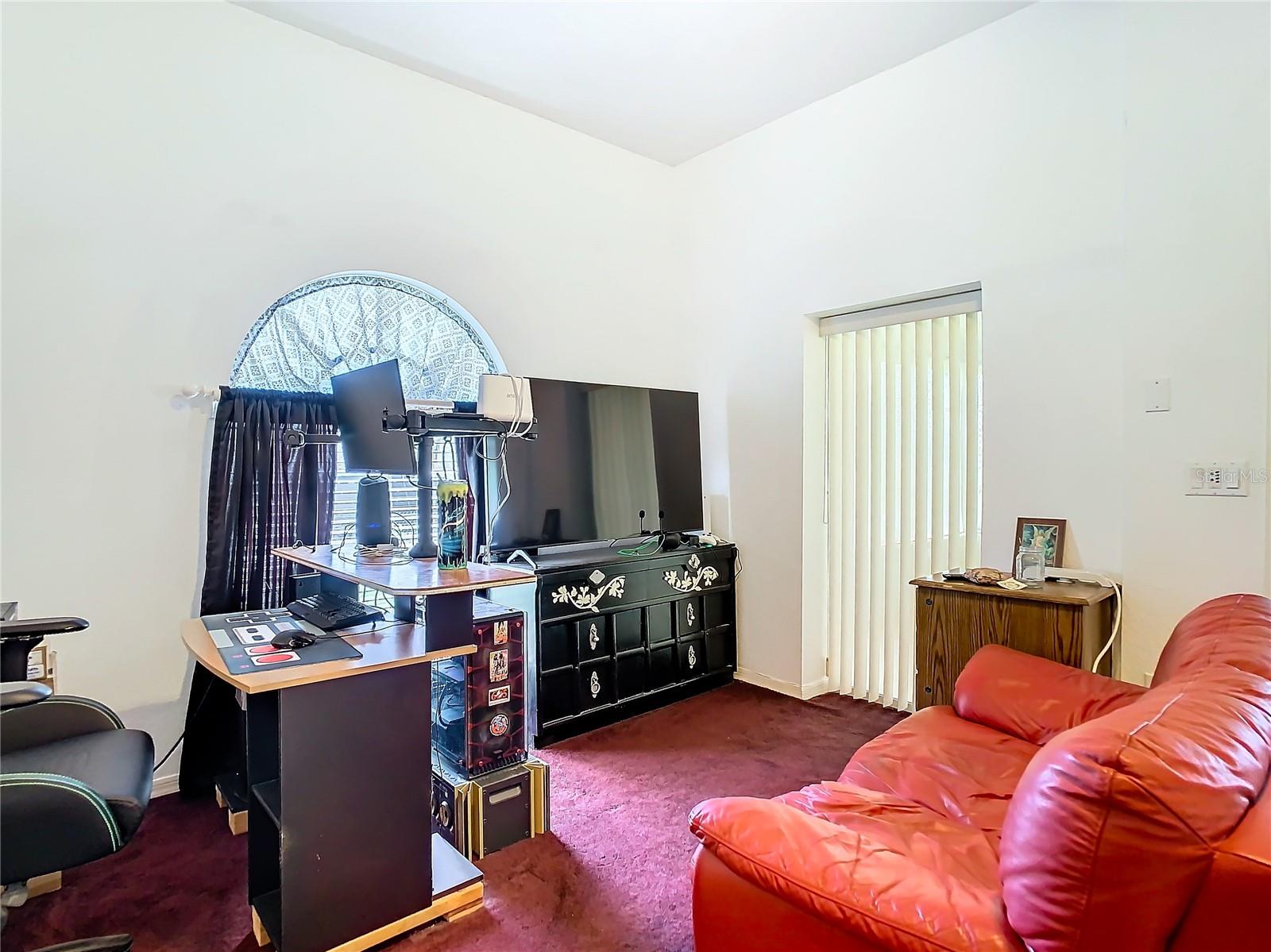 You have access to the lanai from the primary bedroom as well. Room has a ceiling fan and a large window at back of room for that good old natural light.