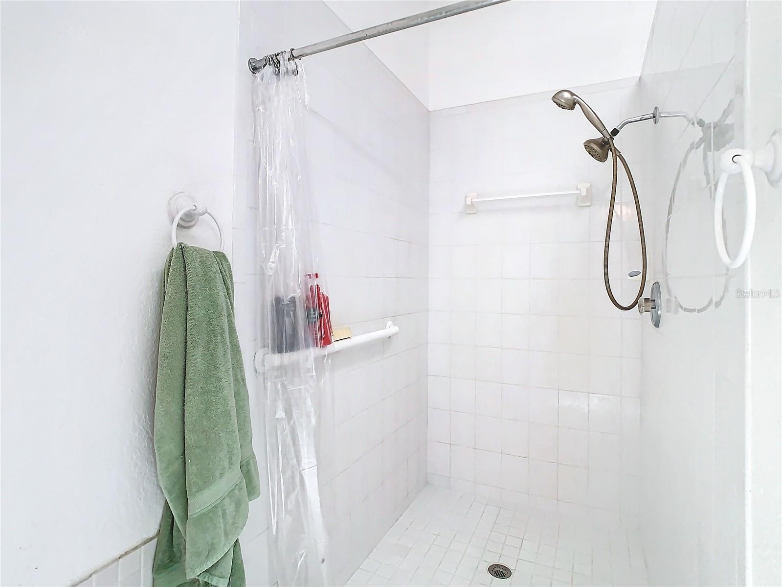 The primary bathroom also has a large walk in shower. There is also a sky light present. Next to the shower (not shown) is a large walk in closet as well.