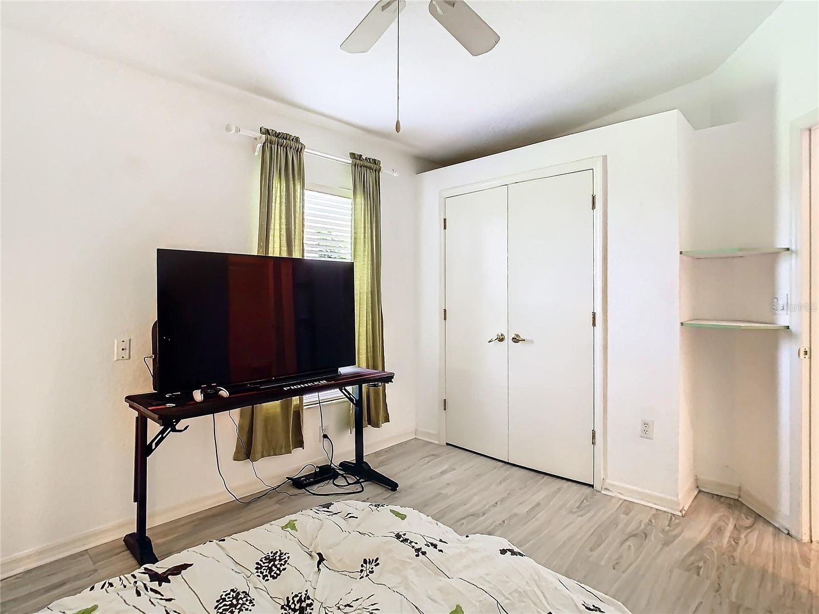 Bedroom 2 is located at the front of the home. Room has a double door built in closet and a ceiling fan.