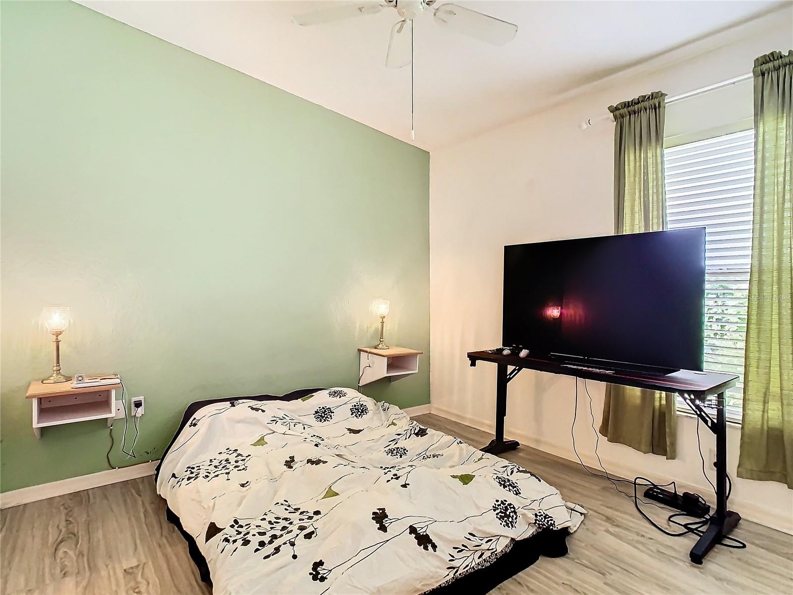 Bedroom 2 sits on laminate flooring. Notice the 2 small built in night stans attached to back wall.