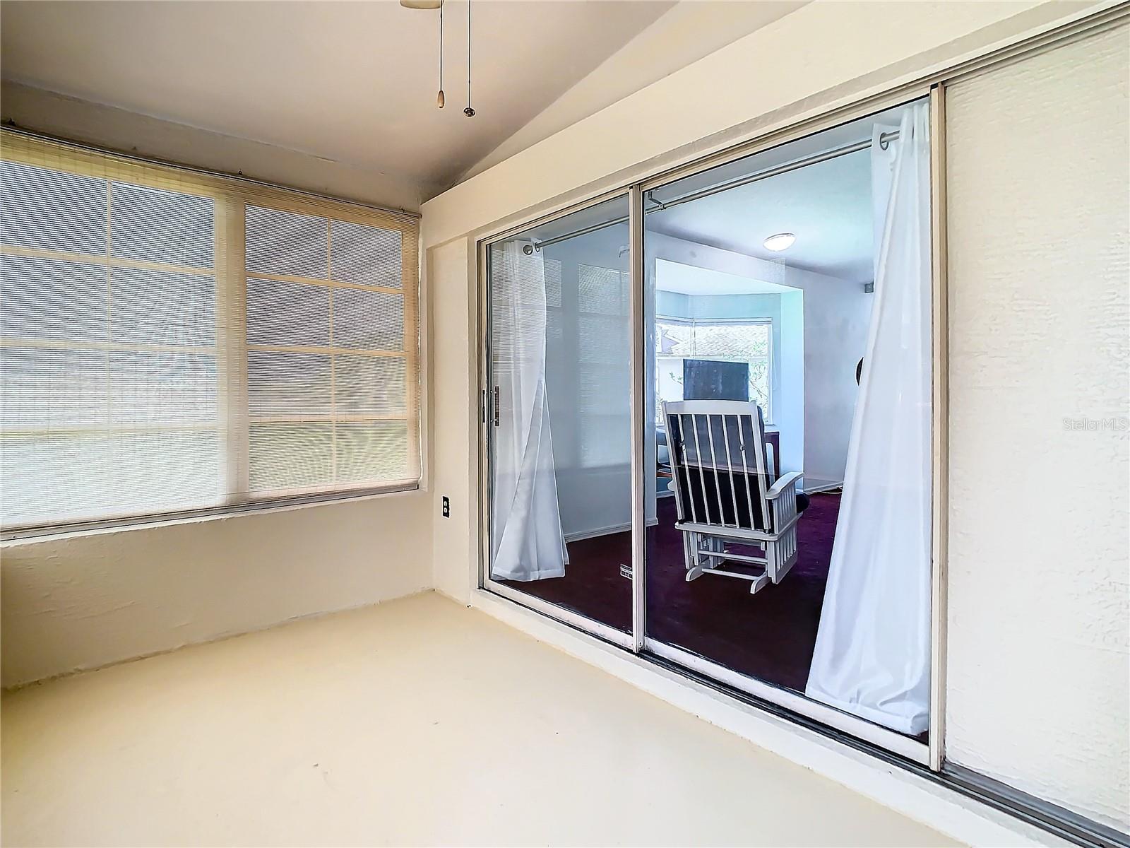 Lanai with large double sliding door into the living room. A great space to enjoy on the cooler days.