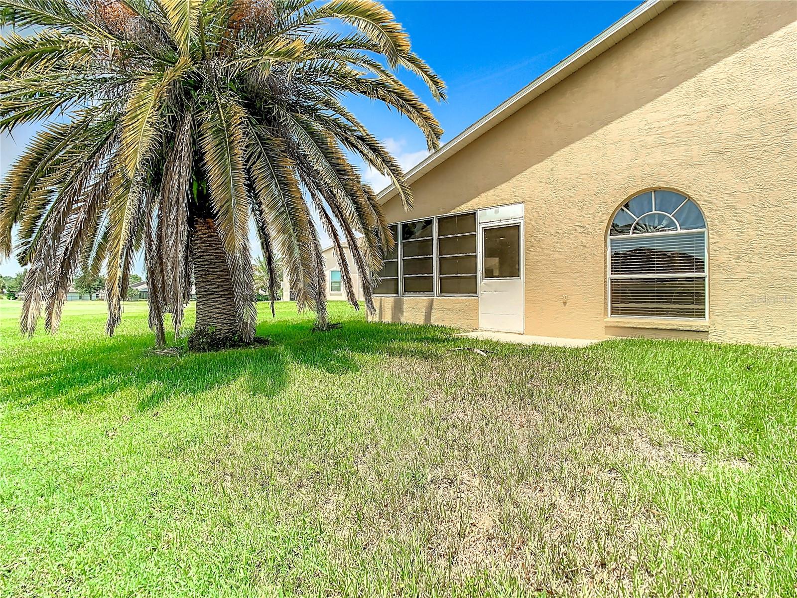 Rear view of the villa. Door opens into the lanai. The large window is located in the primary bedroom.