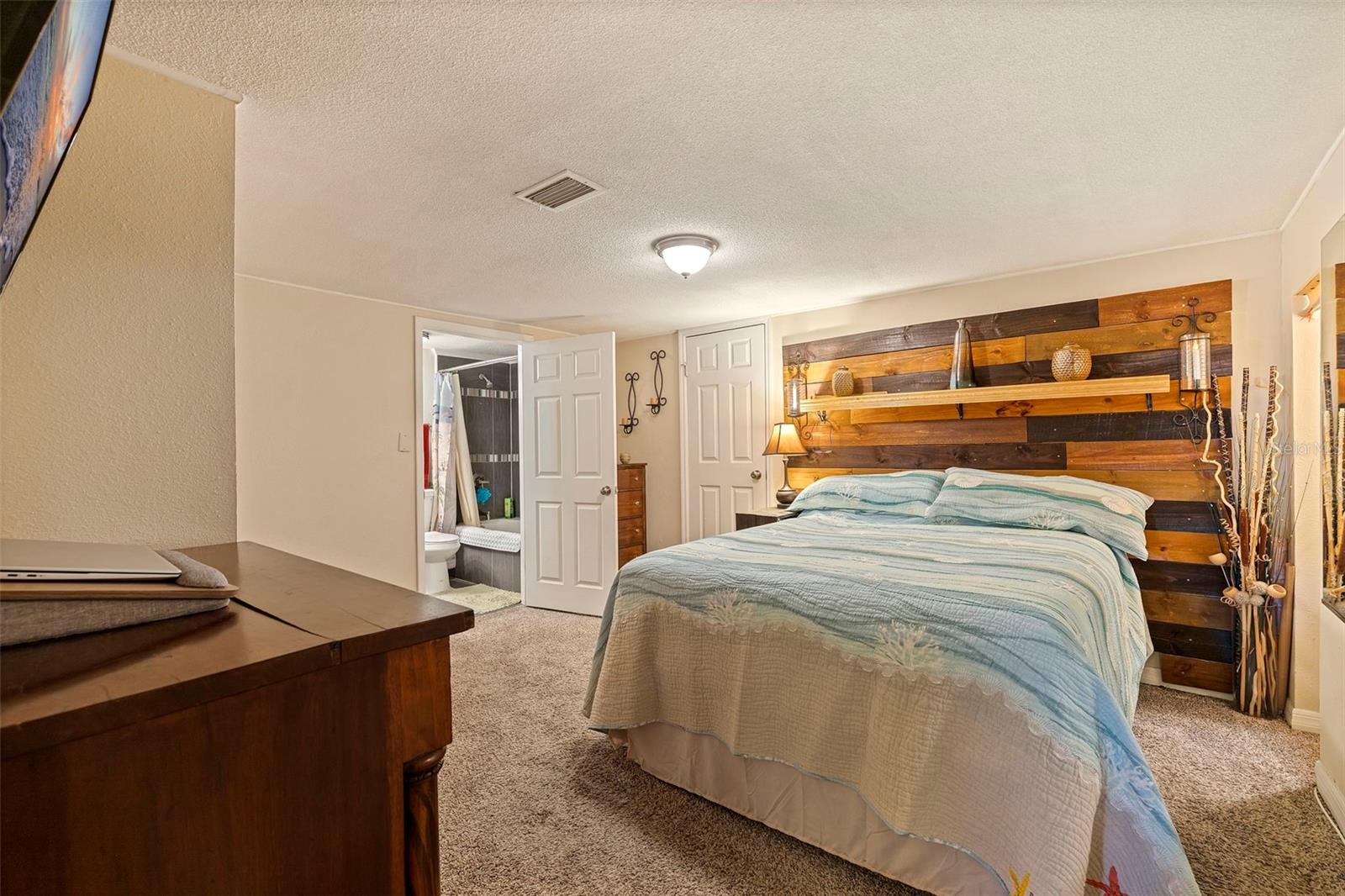 Primary bedroom with feature wall/headboard