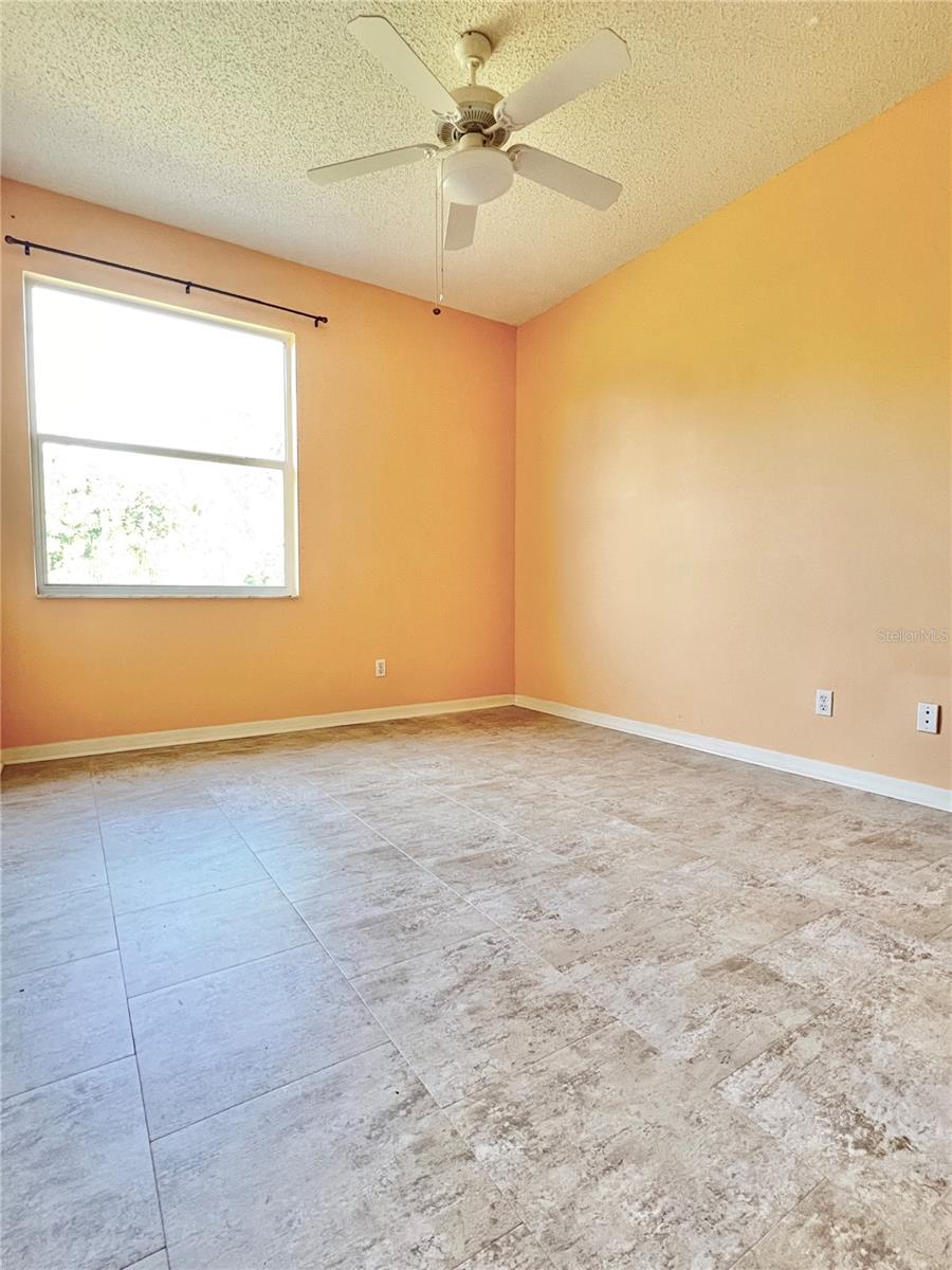 The primary bedroom is large and has TWO closets, updated tile flooring, and a lighted ceiling fan!