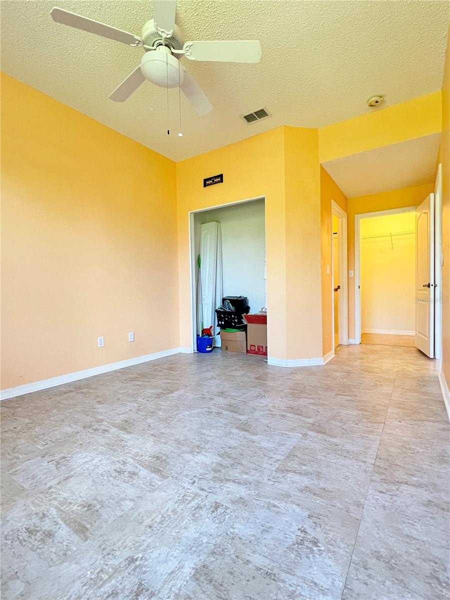 The primary bedroom is large and has TWO closets and a lighted ceiling fan!  The closet doors are stored in the closet.