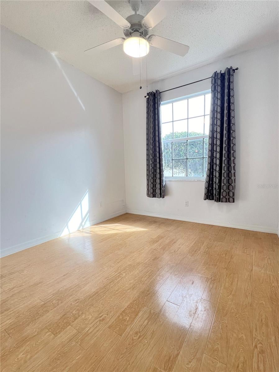 The second bedroom is spacious and has laminate flooring. This room gets a lot of natural light.