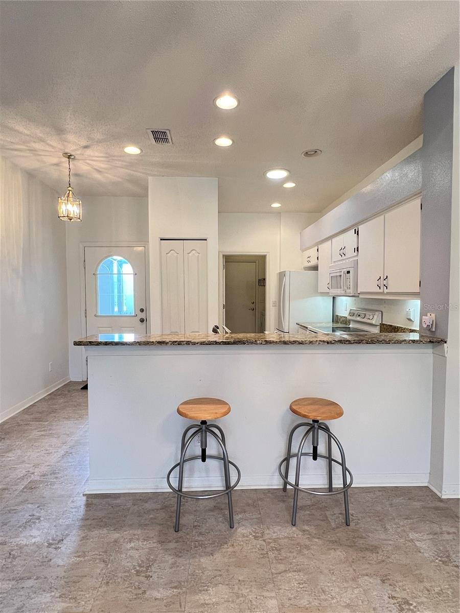 Inside, you'll enjoy your beautiful kitchen with updated granite countertops, recessed lighting, and a breakfast bar that looks out to the great room.