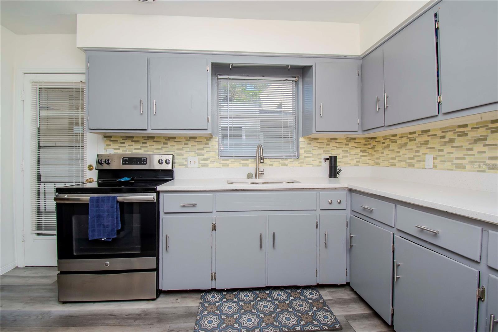 Open kitchen and door to the side of the home.