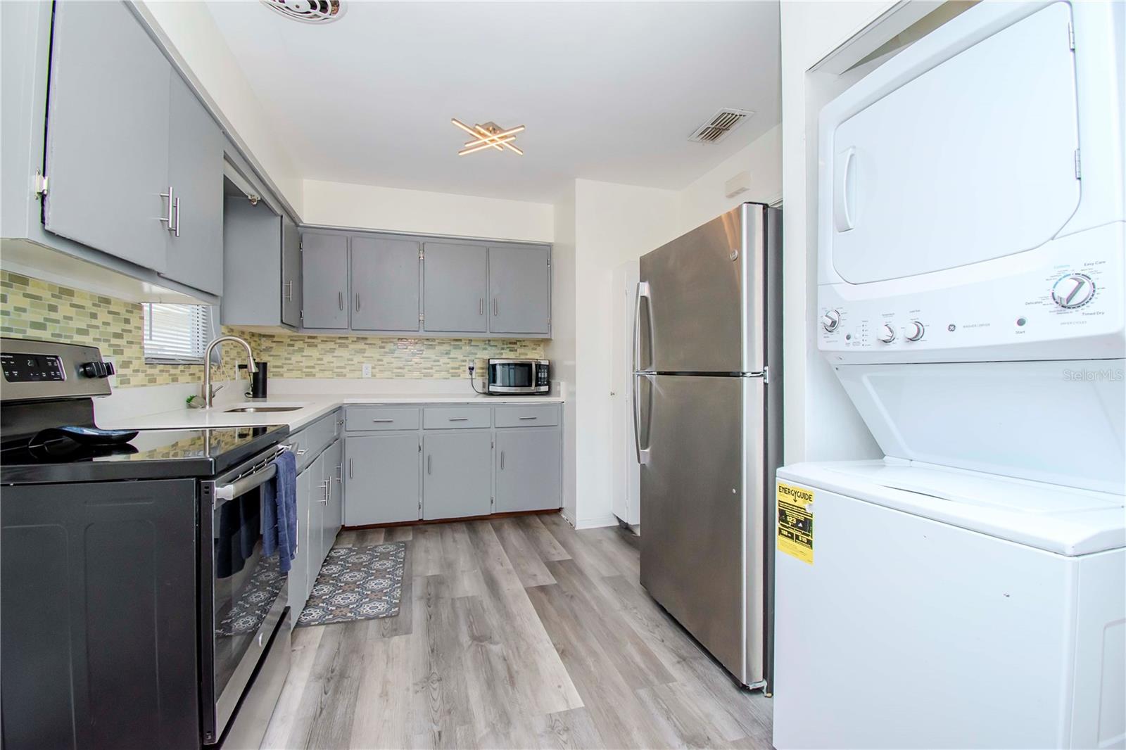 Washer and dryer stackable in kitchen.