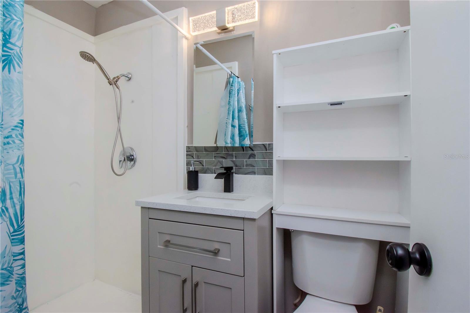 Primary bathroom with large shower and updates.