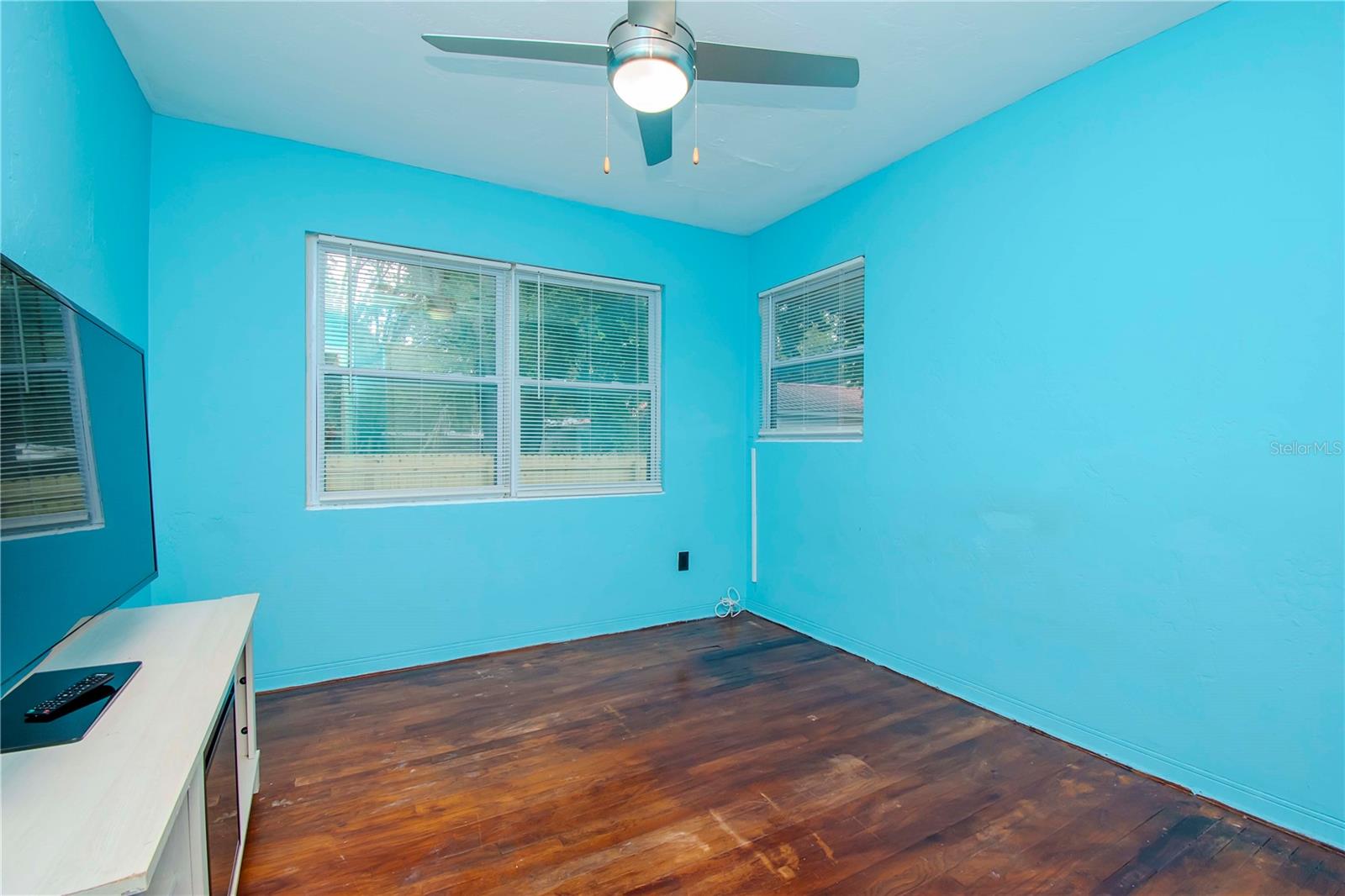 Bedroom 2, original wood floors.