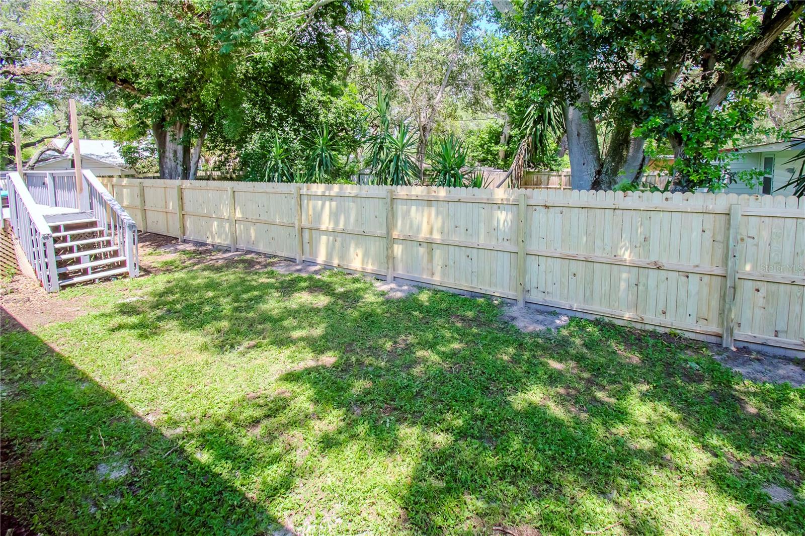 Check out that lovely fence!! The stairs go to the large deck.