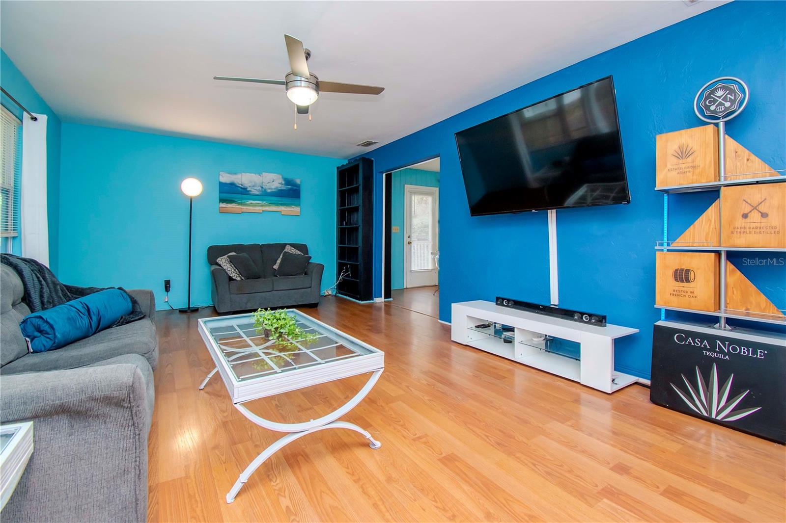 Living room with view into the eating area and front door