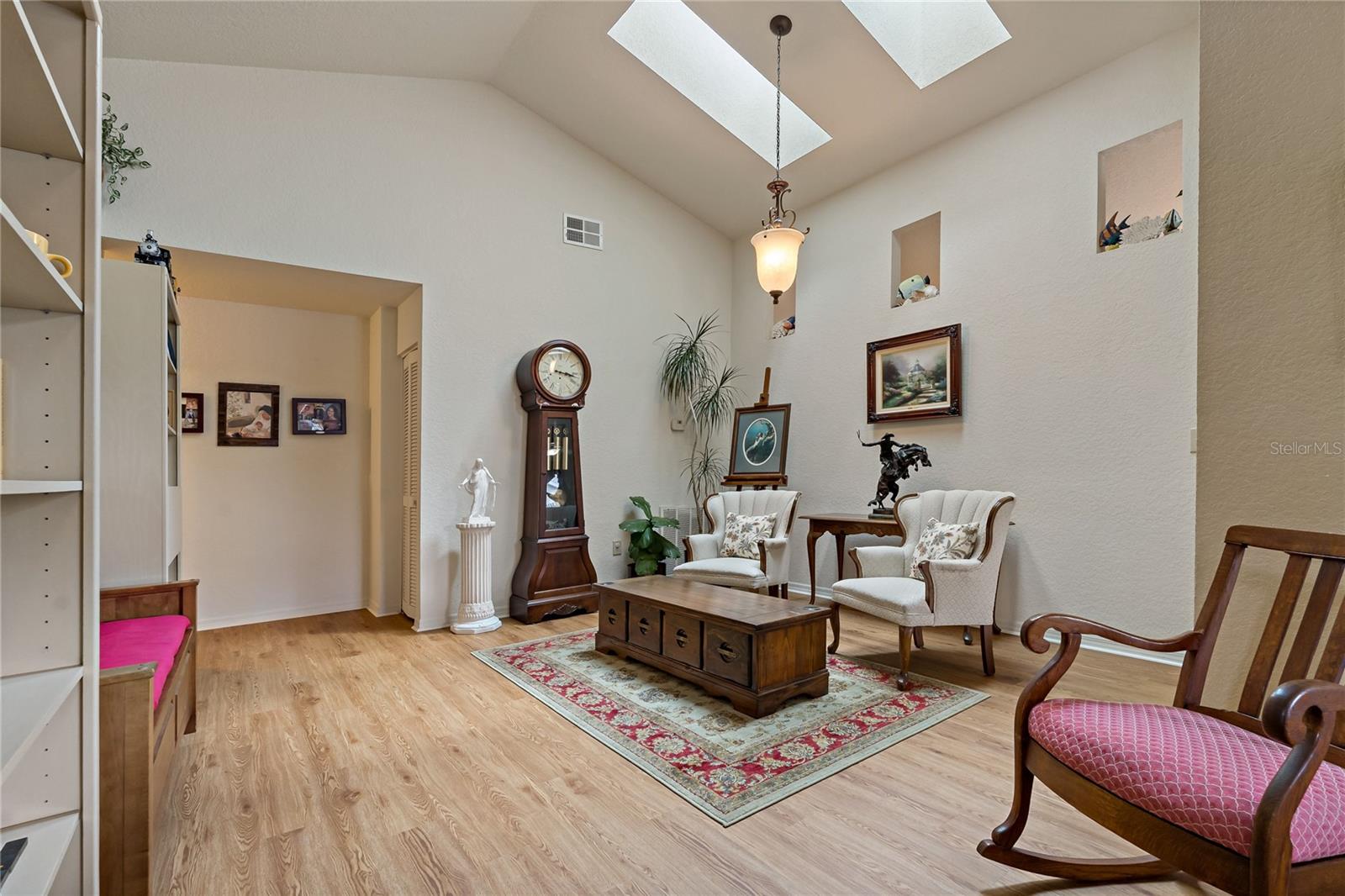 Dining Room with Two Skylights, Open Wall Niches into Kitchen and Wood Laminate Flooring