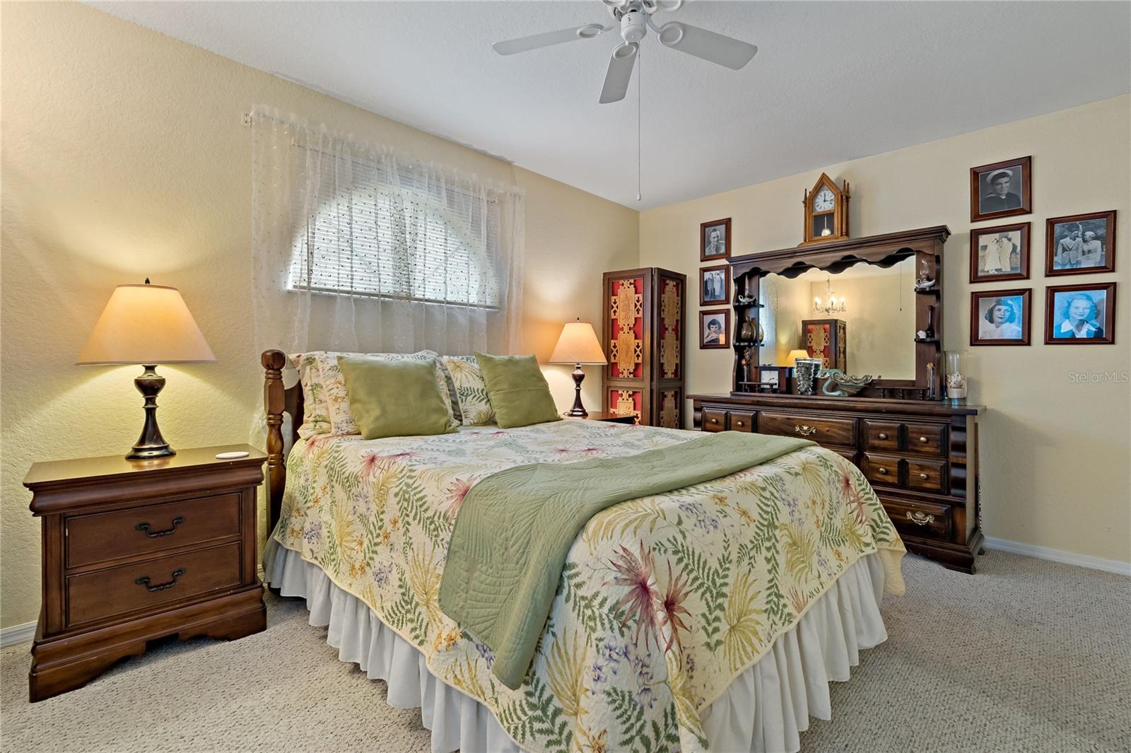 Guest Bedroom with Berber Carpet, Walk In Closet, Ceiling Fan and Arched Window over Bed