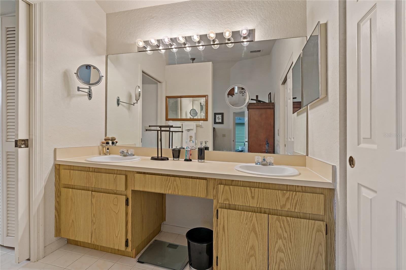 En Suite Vanity with Double Sinks - Walk In Closet Door on Right, Pocket Door to Shower on Left