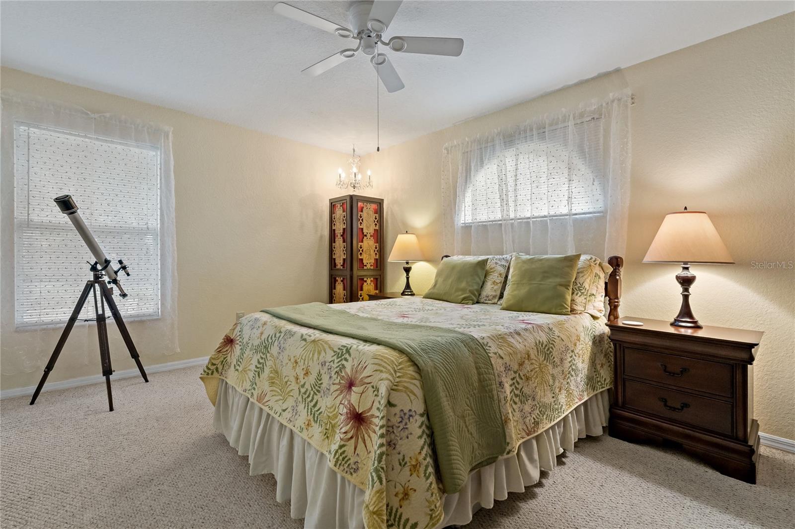 Guest Bedroom with Berber Carpet, Walk In Closet, Ceiling Fan and Arched Window over Bed