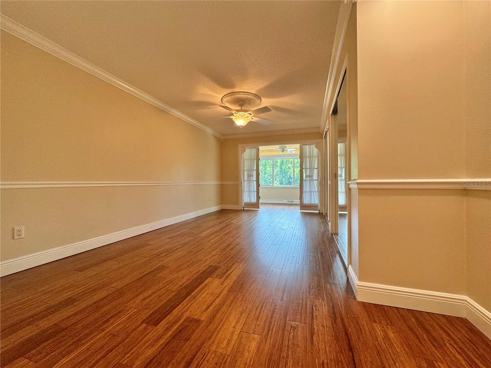 Primary bedroom, barn doors partially open to sitting room.