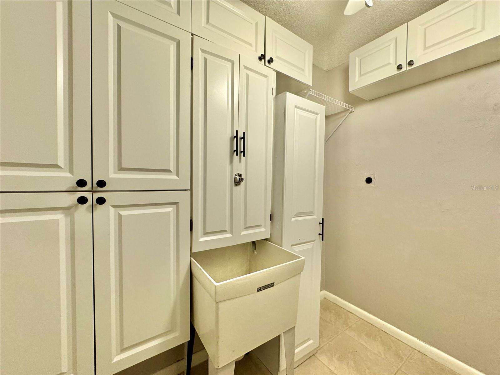 Inside laundry room with utility sink.