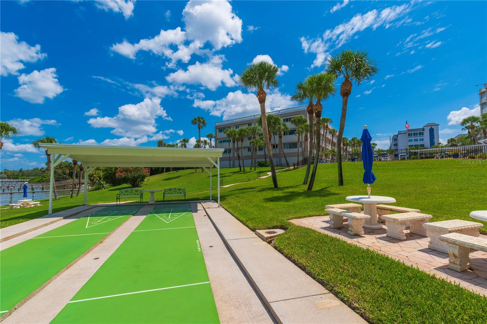 Shuffleboard courts and tables with umbrellas.