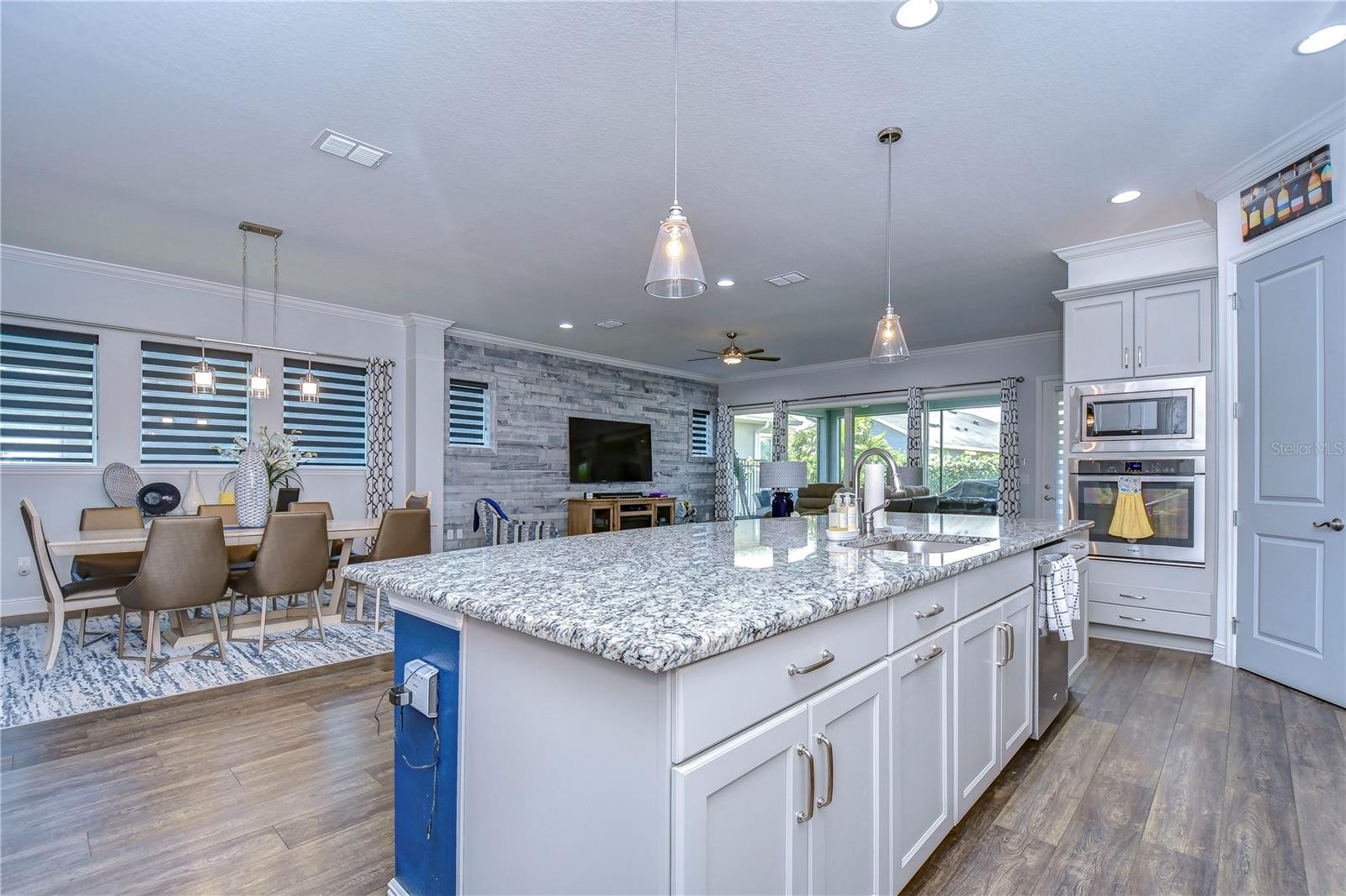 Large open kitchen leading into the spacious living area with beautiful statement lighting!