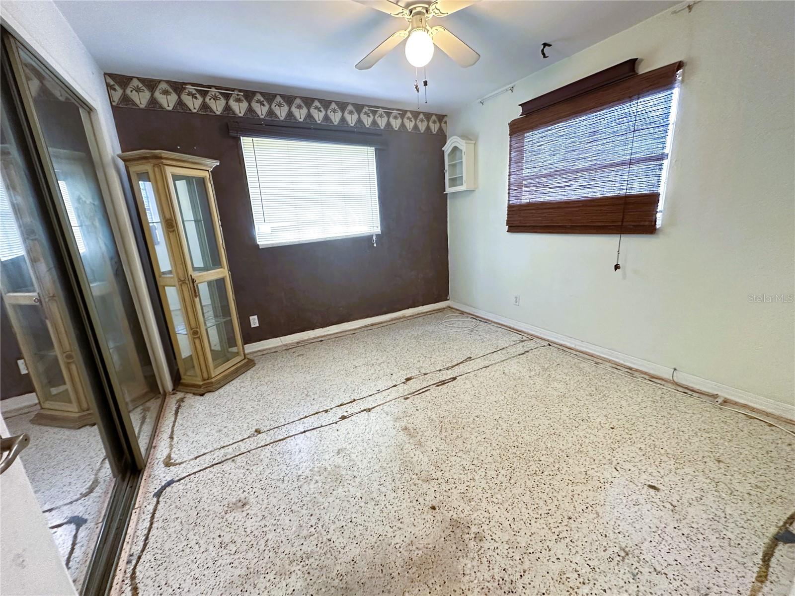 bedroom 2 with carpet removed to expose terrazzo