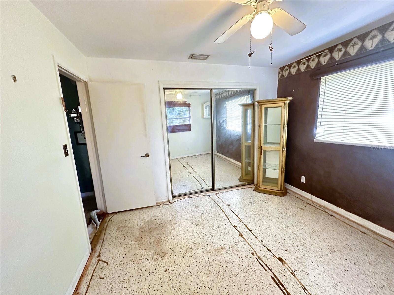 bedroom 2 with carpet removed to expose terrazzo