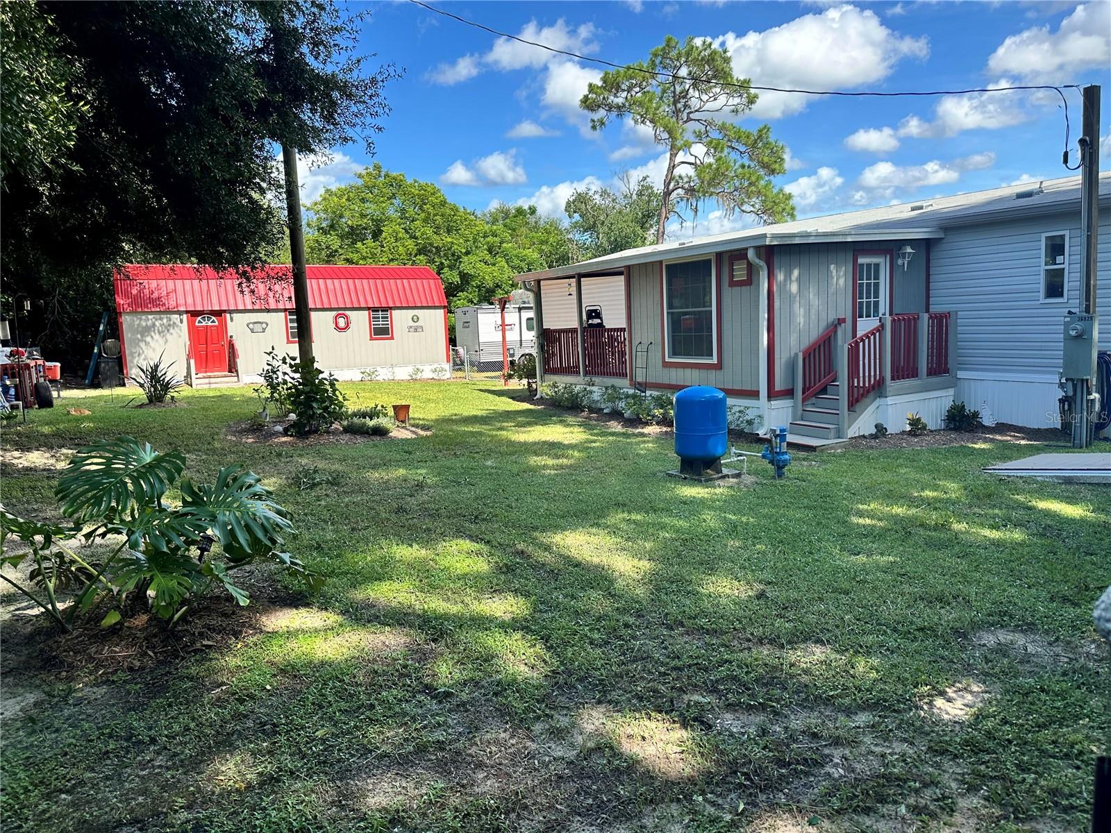 Backyard showing back of home and large shed