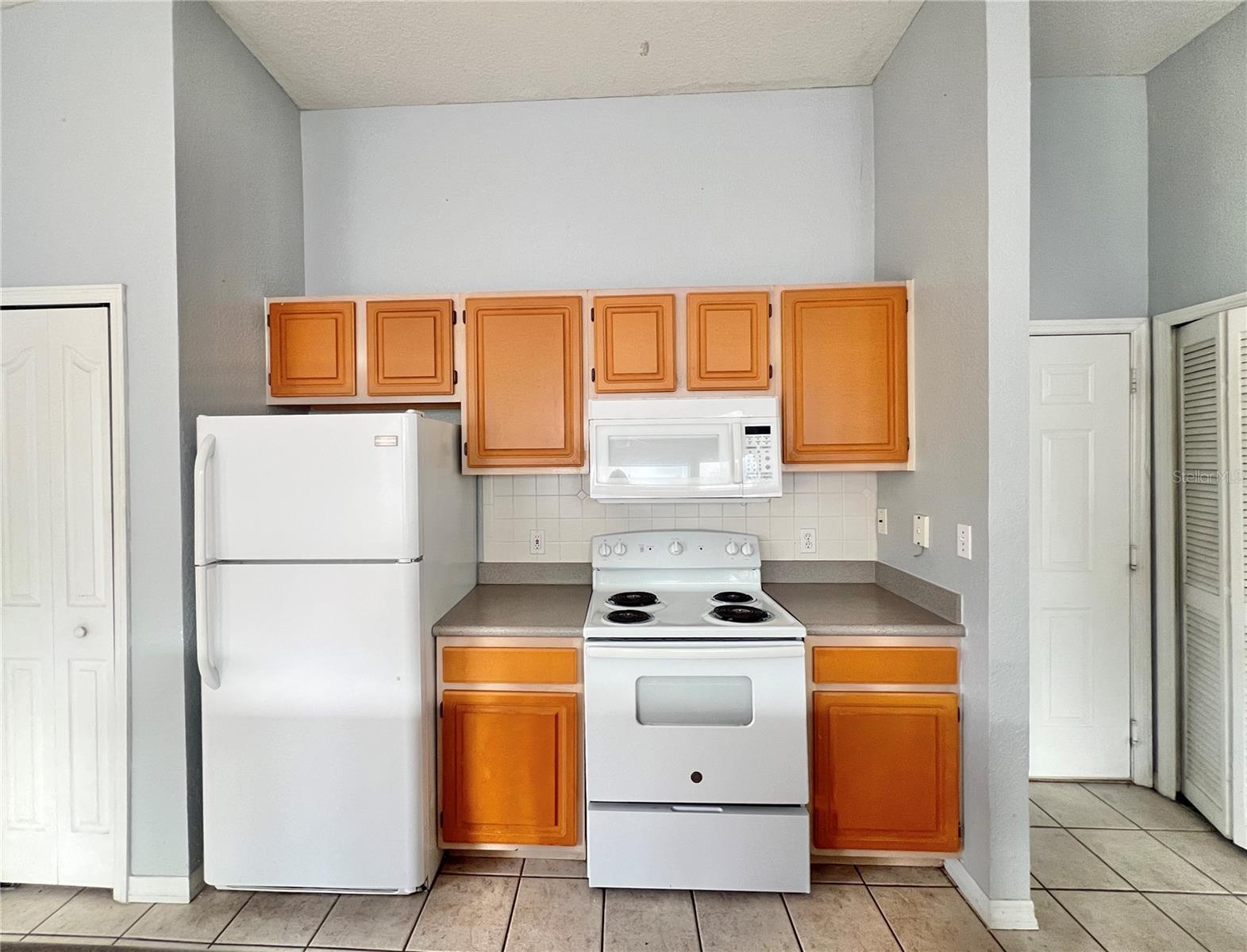 The kitchen has great potential, and there's an island across from this wall.