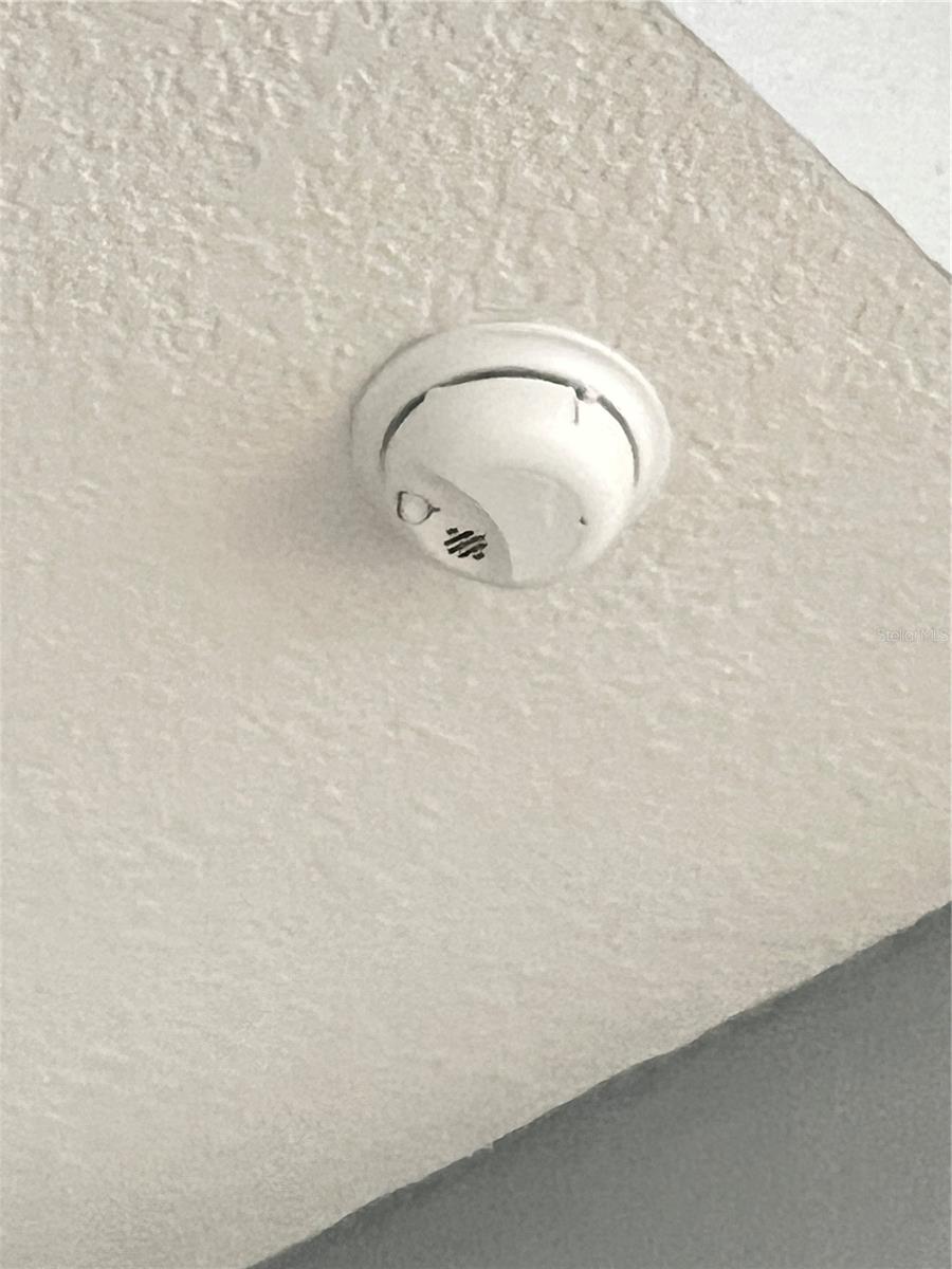 Smoke detector right outside bedroom.