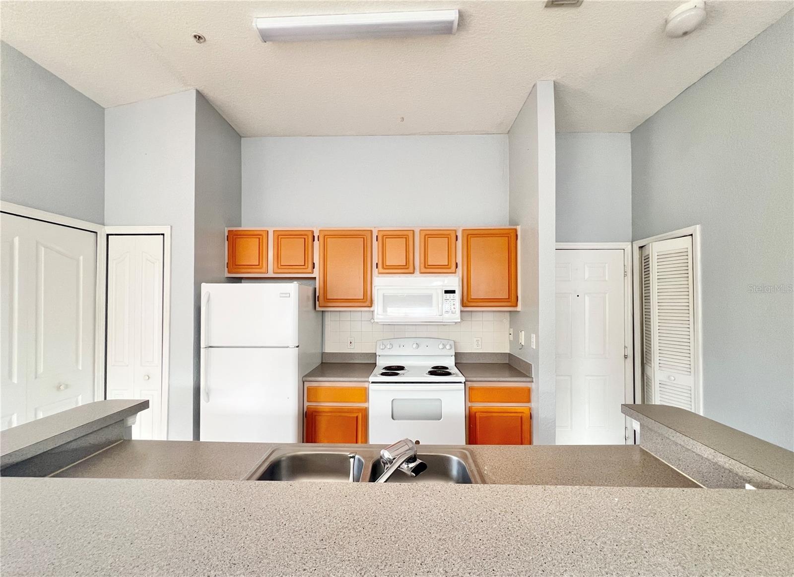 The closet pantry is left of the refrigerator.