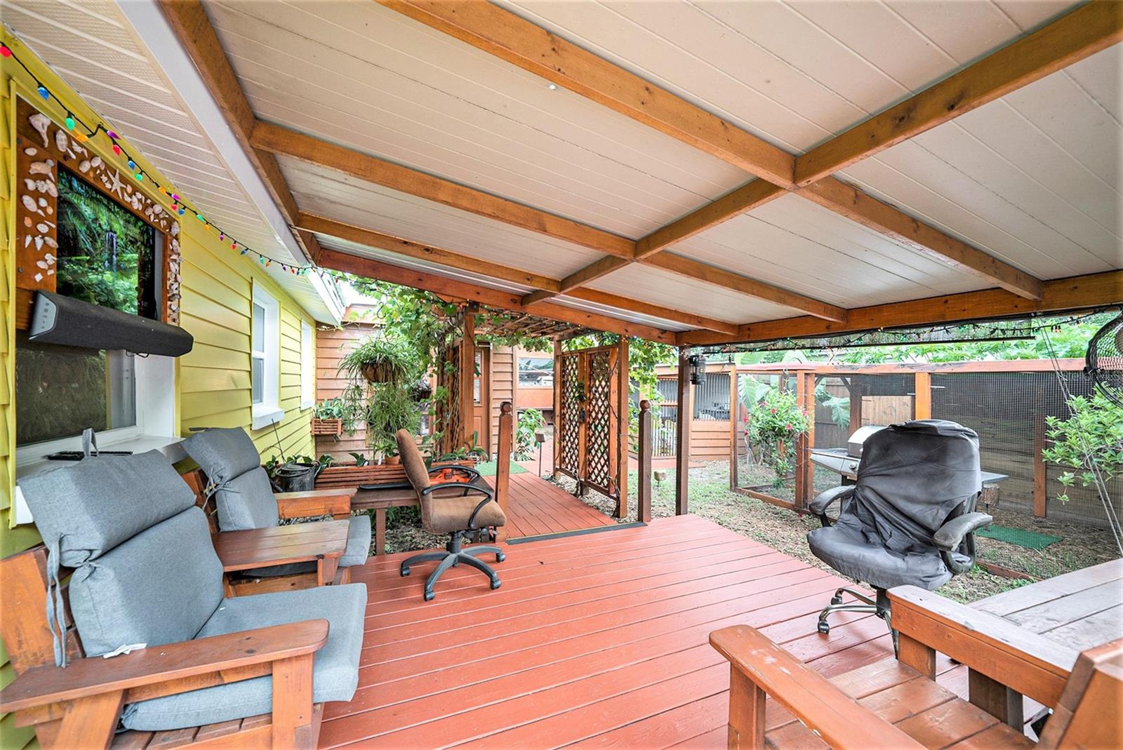 Enter through an arch of six five-year-old grape vines that yield 30lbs of grapes, leading to a cozy TV lounge area.