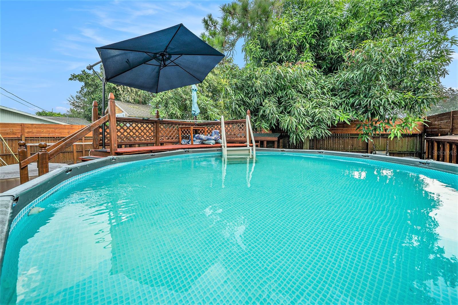 Above-ground saltwater POOL and HOT TUB, completed with a wrap-around DECK.