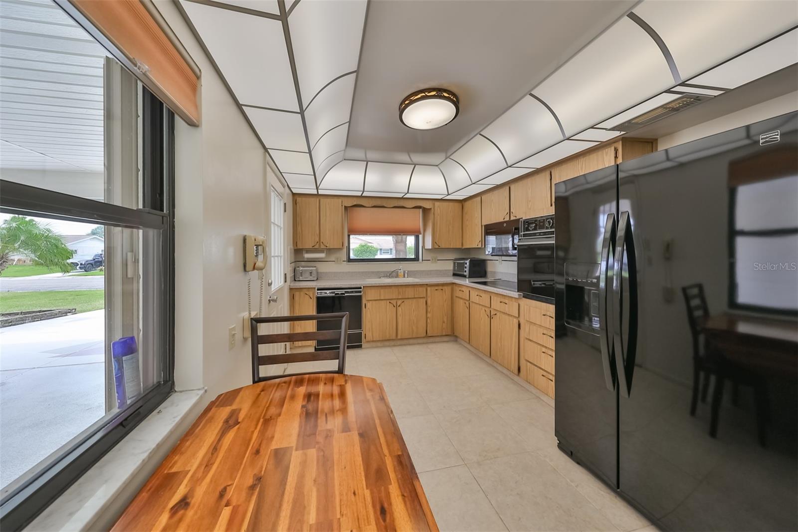 Large windows bring natural Florida sunshine into the eat-in kitchen.