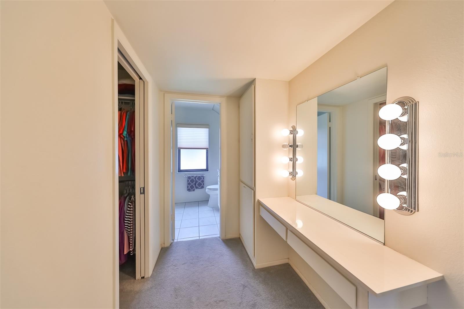 There is a walk in closet, storage cabinets and makeup desk in the master bedroom.